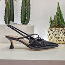 Patent leather shoe with black straps