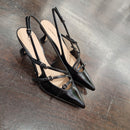 Patent leather shoe with black straps