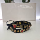 Campomaggi bracciale nero con corallo e  borchie oro